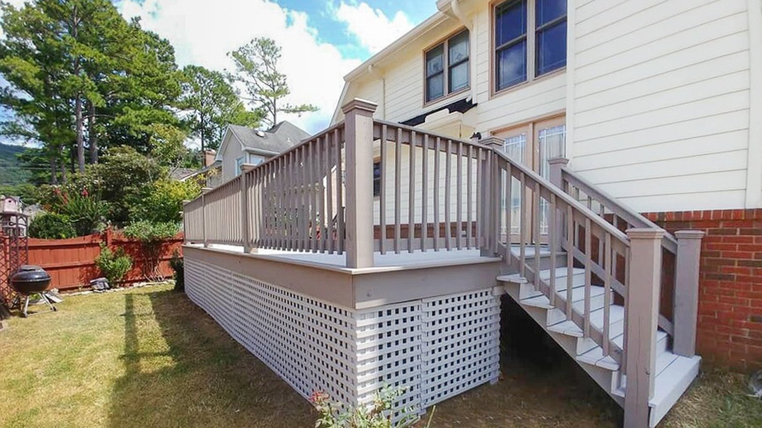 Small white house with wooden deck